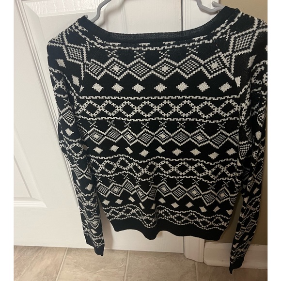 Black and white sweater with a teal colored dinosaur. - Picture 2 of 4